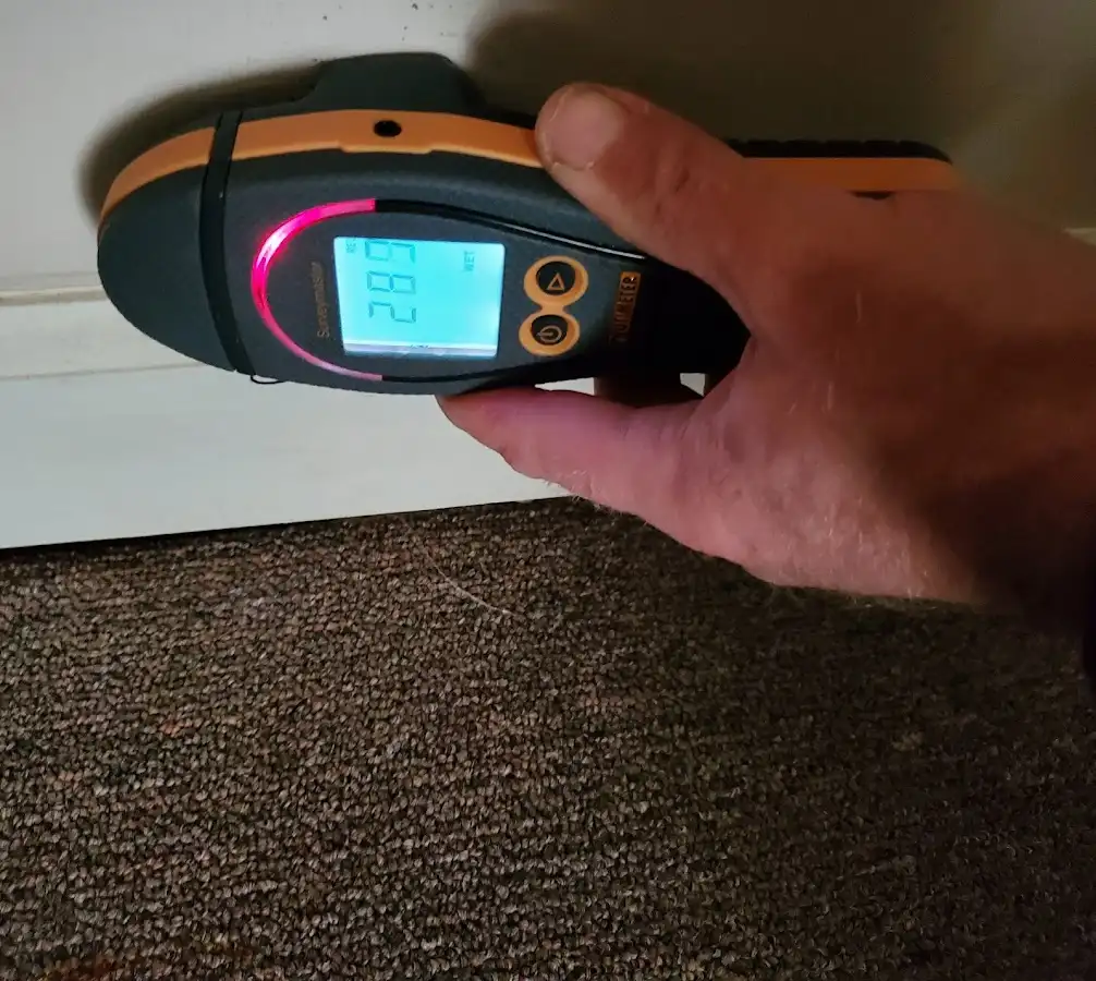 Moisture detection at baseboard during Storm Damage Restoration in Woonsocket